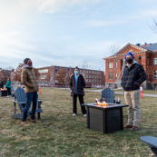 Photo of fire pits on the oval with people socially distancing and talking
