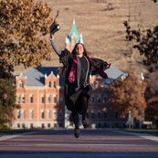 Photo of student jumping on the oval