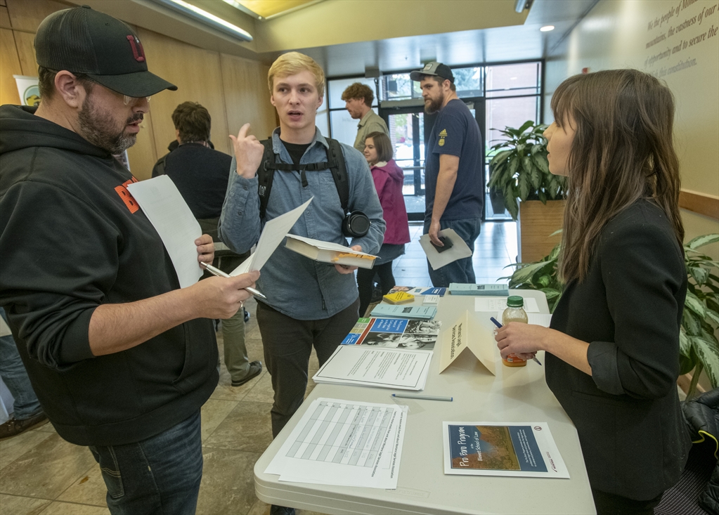 Akemi Nakagawa, Montana Legal Services Association Justice for Montanans Member, speaks to Christopher Morigeau and Forrest Crowl during the 2019 Pro Bono Fair (the 2020 Pro Bono Fair was held virtually)