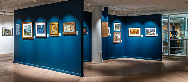 blue walls with paintings in gallery
